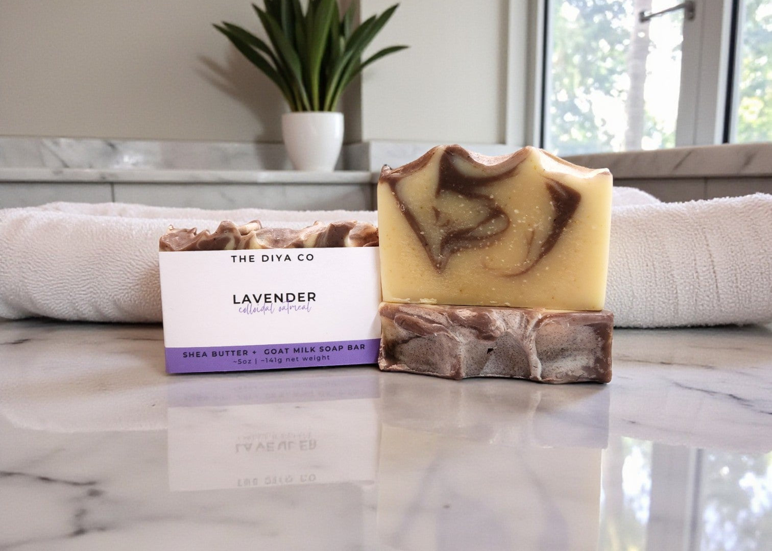 Marble countertop with a bar of soap and packaging labeled 'The DIYA Co.'