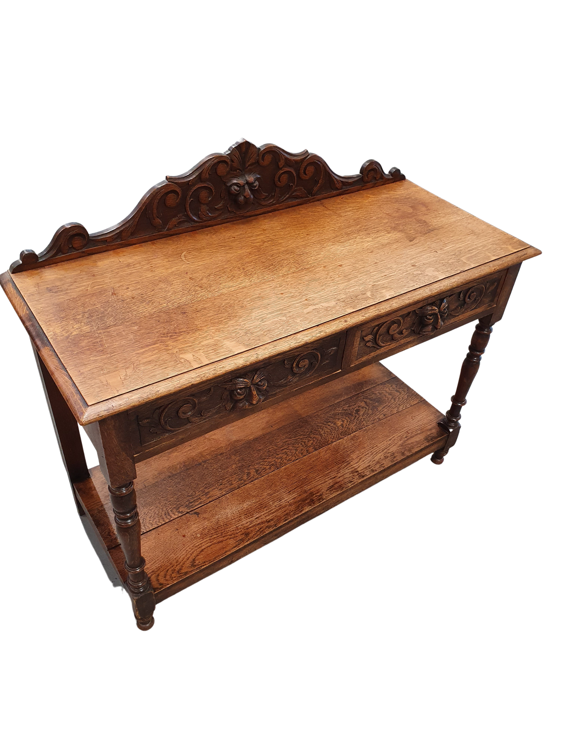Victorian Gothic Oak side table, decorative carved round 1920. Green Mask decoration