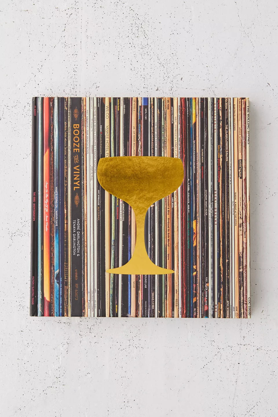 Booze & Vinyl book laying on a plaster surface