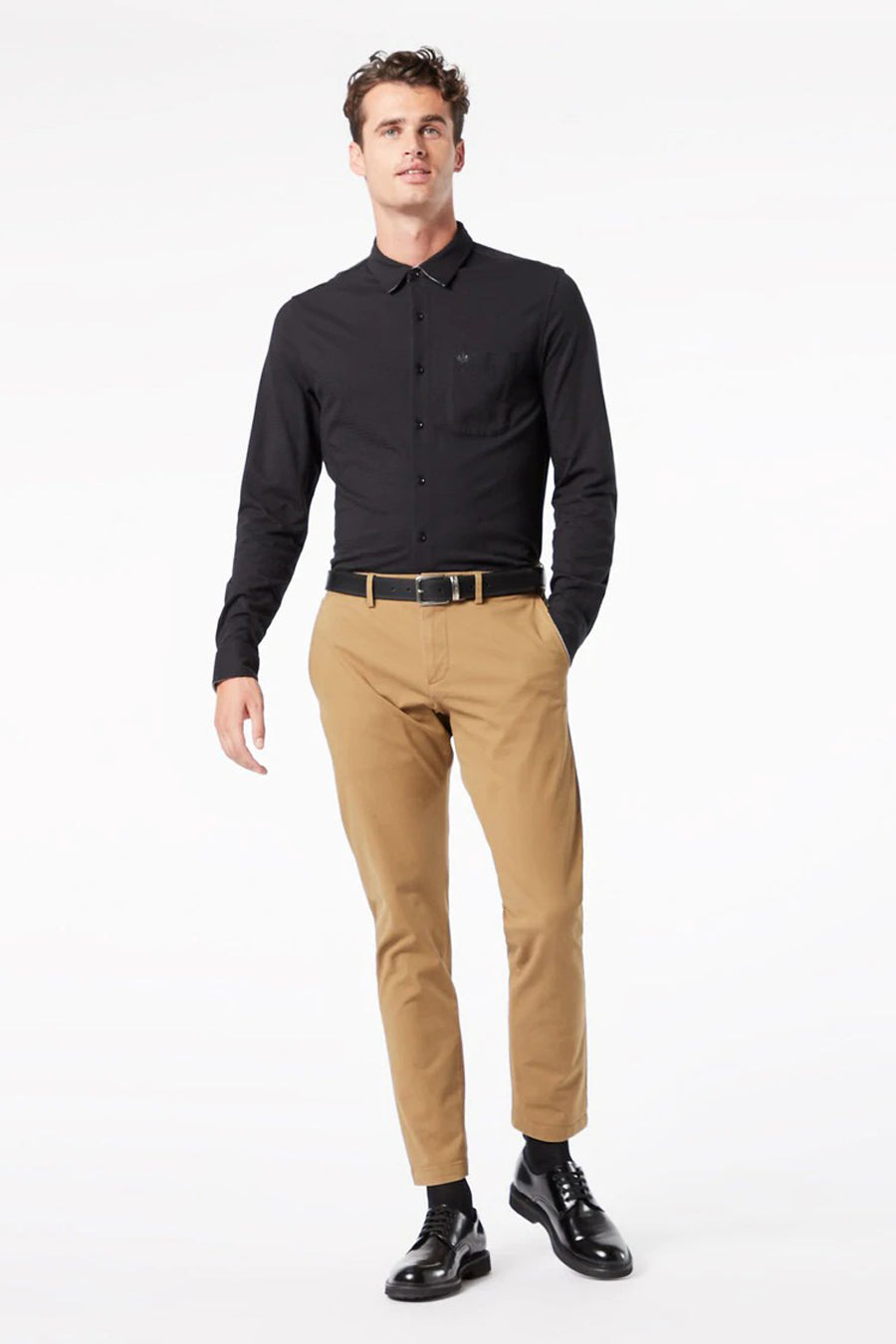 Beige chino de DOCKERS, avec des revers relevés et porté avec un T-shirt blanc et des baskets blanches.