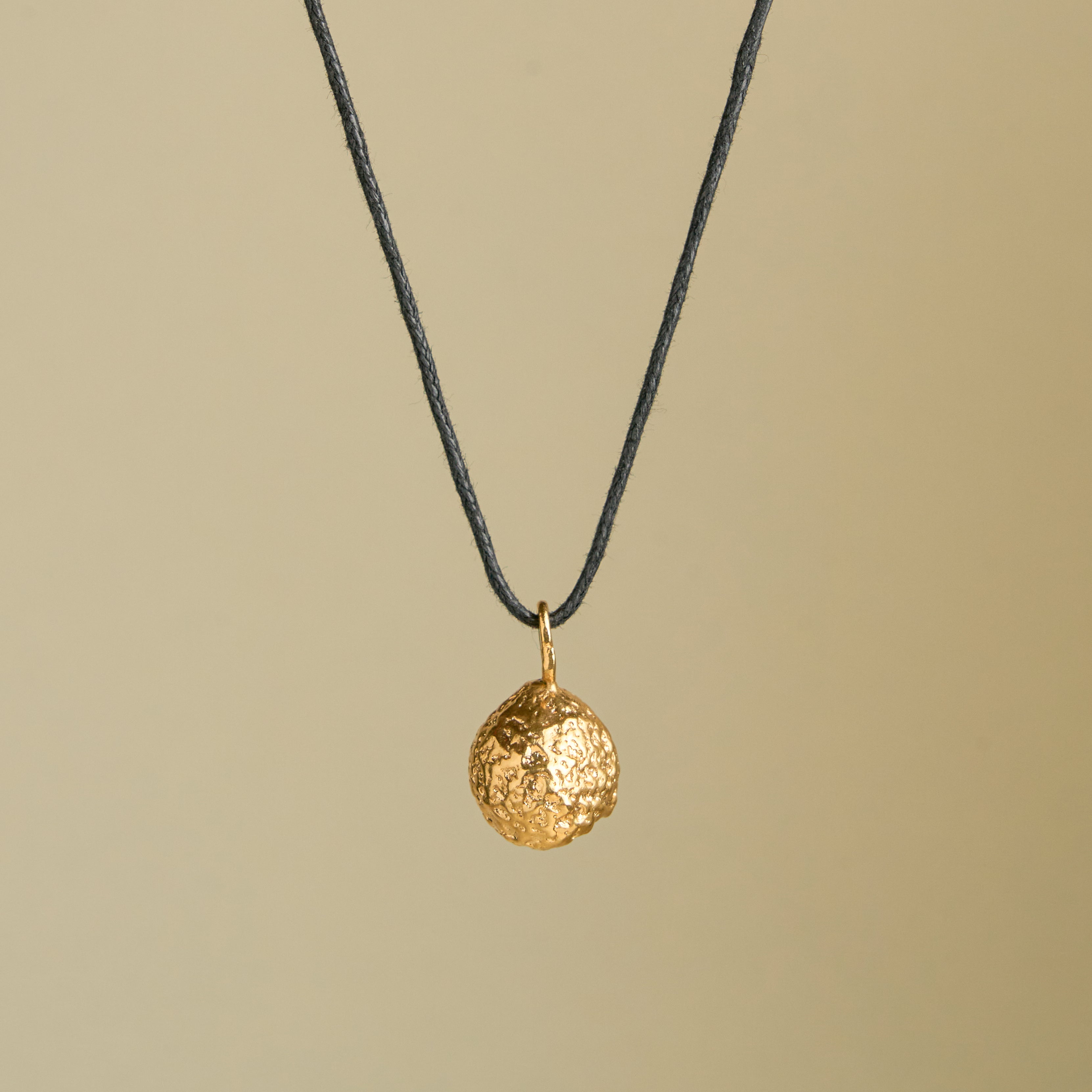 COLLAR NUEZ GRANDE DORADO LARGO HILO NEGRO.