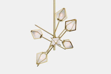An elegant sculptural luxury lighting fixture, the Harlow Small Chandelier inspired by jewellery design, features a mold-blown glass gem in a chic metallic setting. The blown glass, made to order lighting creates a diffused soft light, with the prong inspired hardware adding glamour to each contemporary light fixture.