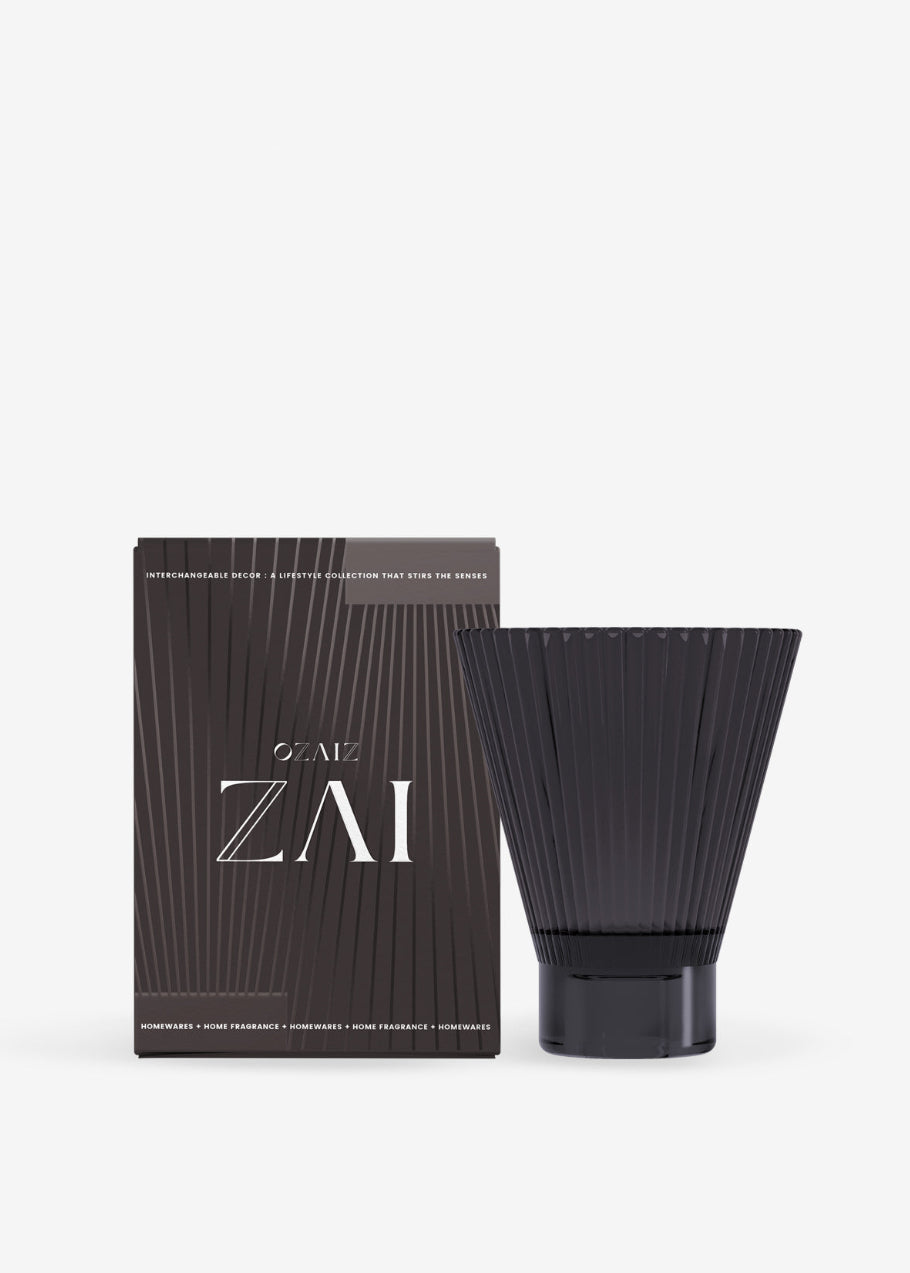Black cylindrical container with ribbed design next to its packaging on a white background