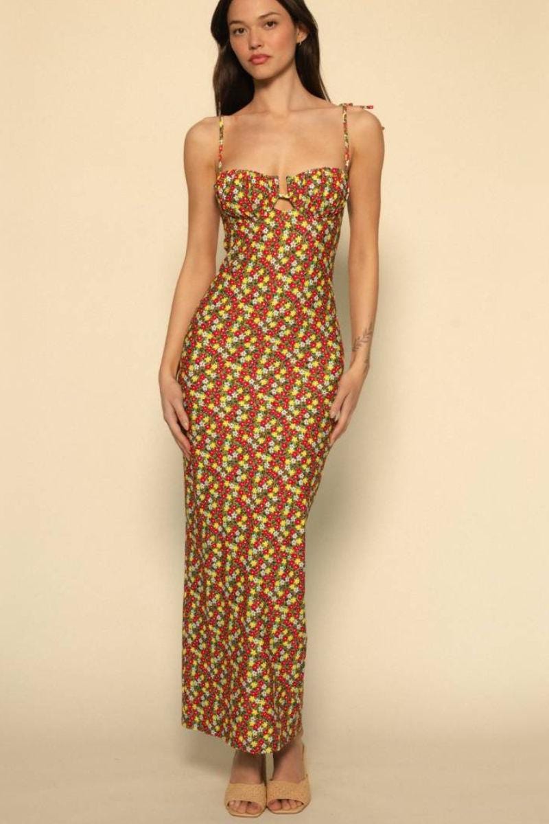 Long slip dress with red, yellow, and white floral print, sweetheart neckline, and thin adjustable straps.