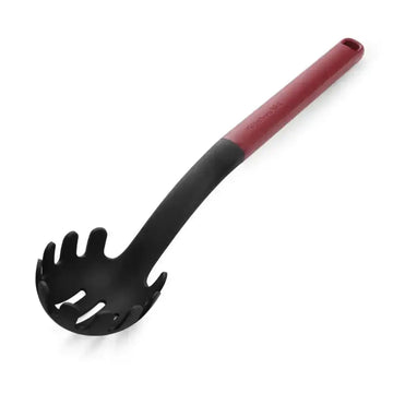 Black pasta server with red handle on a white background