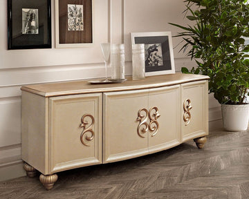 Beige sideboard with decorative elements in a room with framed pictures and a plant.