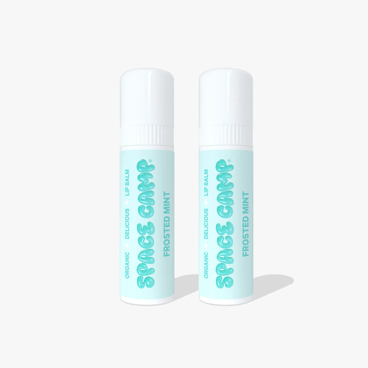 Two Space Camp Frosted Mint organic lip balm tubes with mint green labels and white caps on a light blue background.